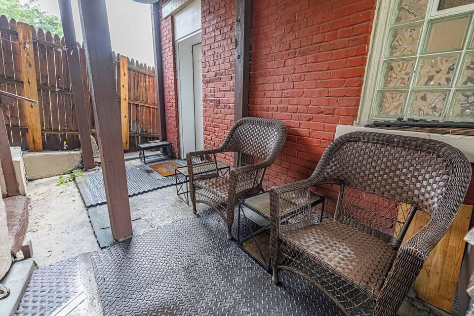 Covered private patio offering a comfortable outdoor space to relax and unwind during your stay.