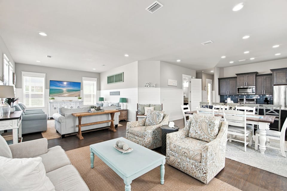 Step into your bright, open living space where coastal charm meets comfort. Soft blues and warm wood tones create a relaxing atmosphere perfect for unwinding after a day of exploring.