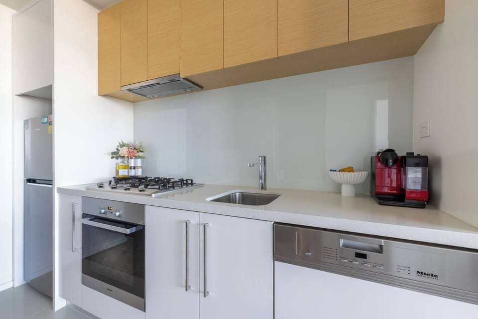 Create delicious meals with ease in the streamlined kitchen, featuring a gas cooktop, Miele dishwasher, full-sized fridge and cooking basics.