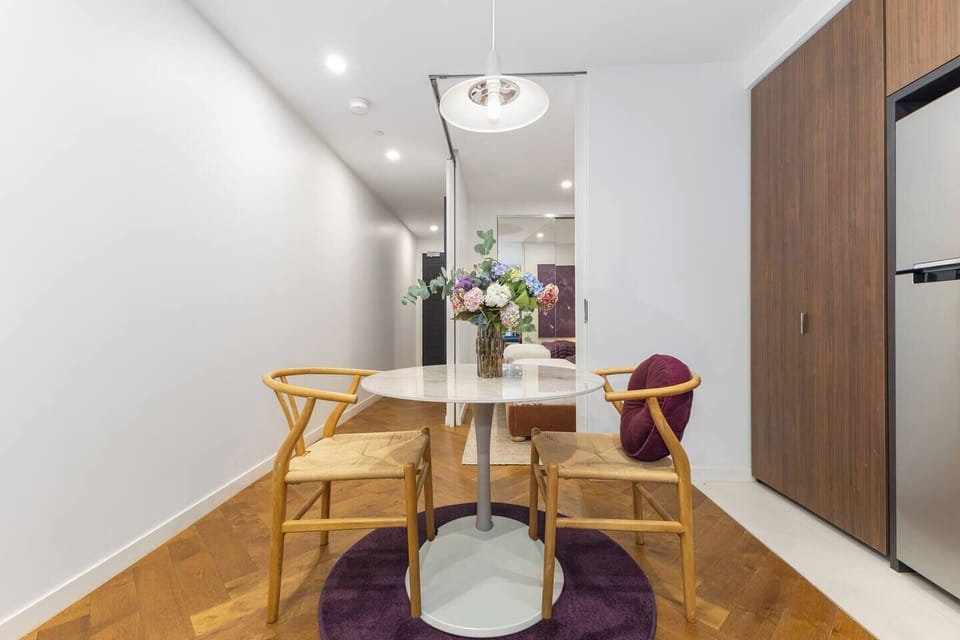 Start your day at the dining table for two, perfect for coffee before heading out to explore nearby boutique-lined streets showcasing everything from European fashion houses to celebrated local designers.