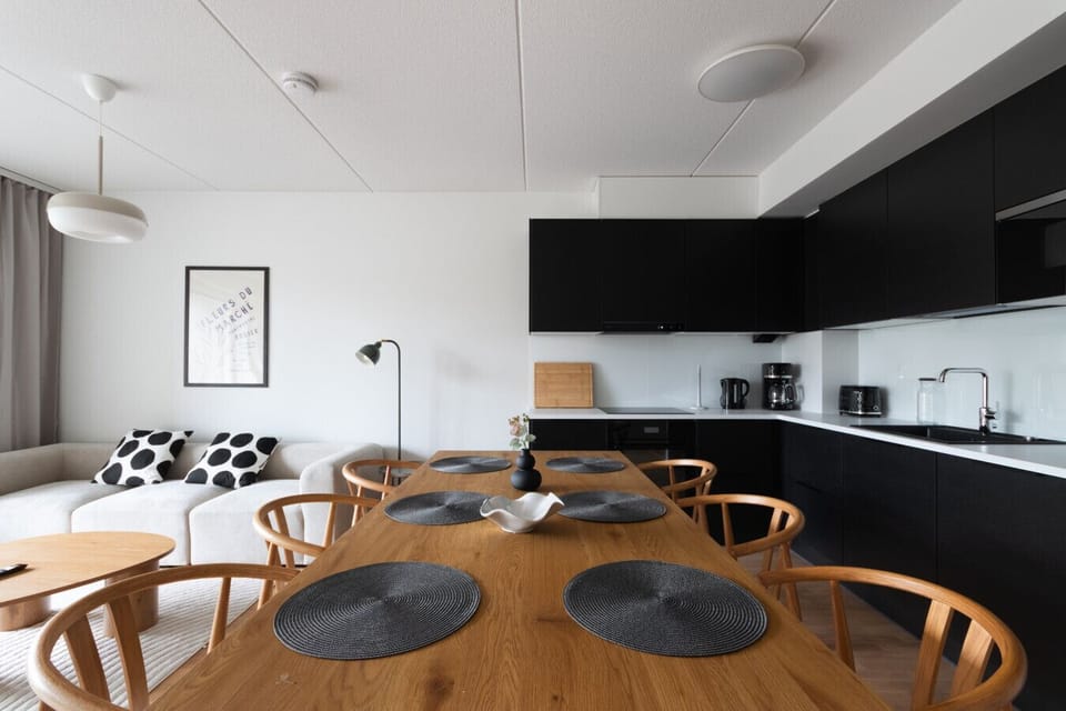 Modern kitchen has large dining table for six.