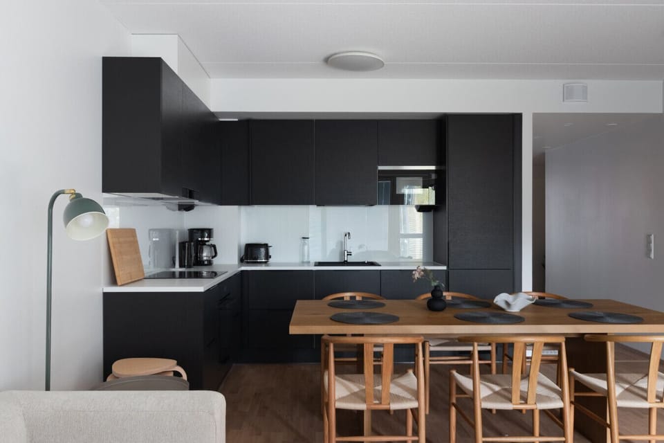 Modern kitchen has large dining table for six.