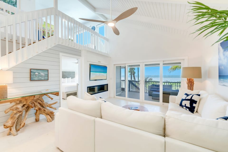 A plush sectional sofa embraces the living space, seamlessly connecting comfort with stunning views.