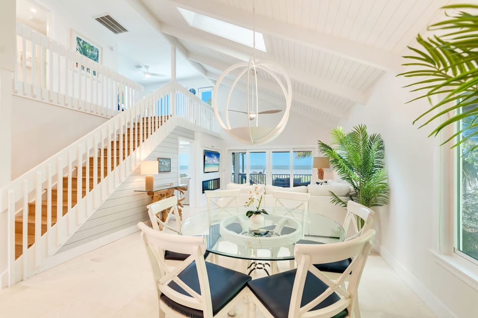 Soft light fills the airy dining area, where the table invites shared meals and laughter.