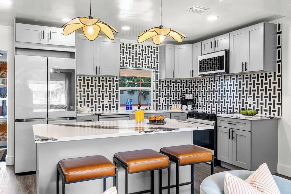 Modern kitchen with vibrant accents, stylish seating & all your essentials!