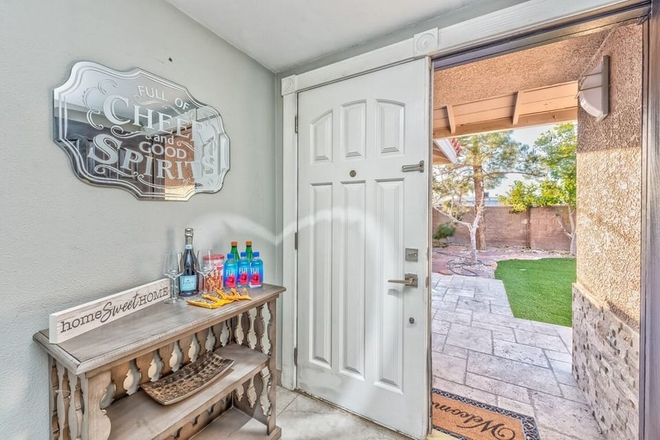 Welcoming entry with stylish decor and private patio-style yard views