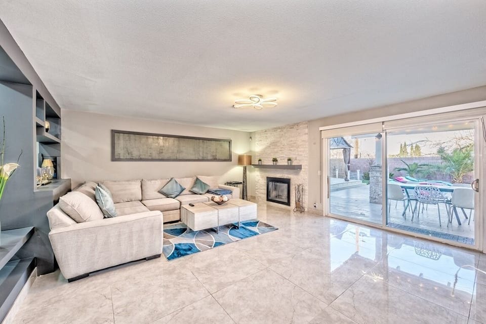 Bright modern living room with fireplace and patio access
