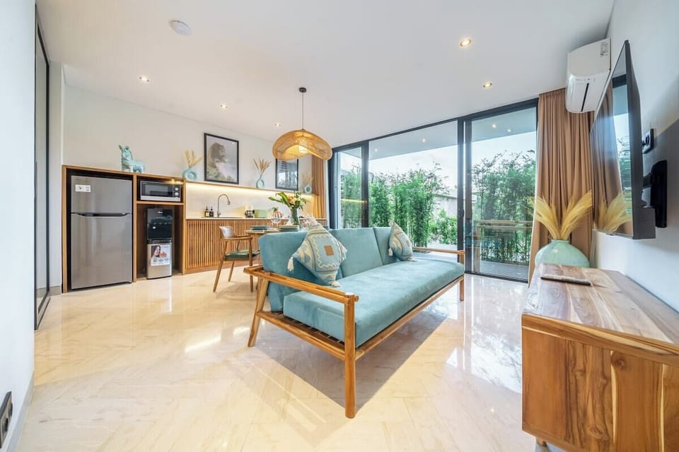 Living Room: Bright and airy space with lush views, perfect for relaxation or entertainment!