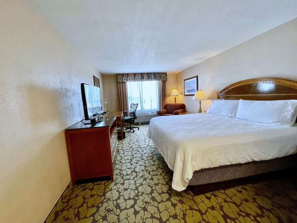 Step into a spacious king room with seating by the window.