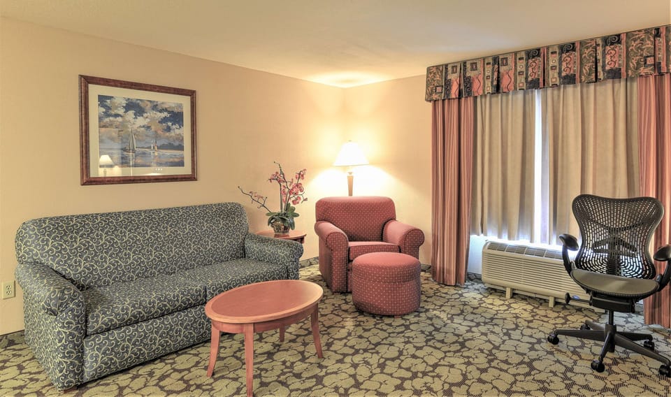 Relax on the cozy sofa beside a soft reading lamp.