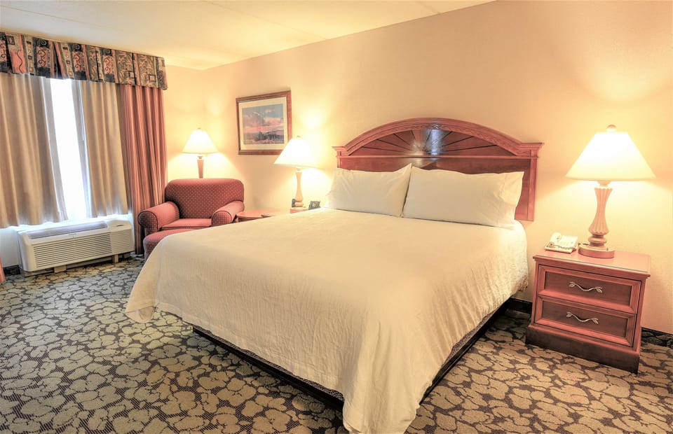 Recharge on crisp linens beside the sunny window nook.