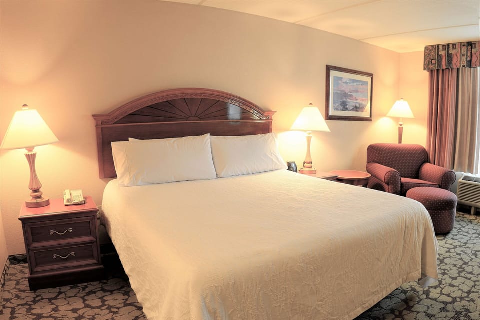 Drift off fast in a serene bed framed by soft lamps.