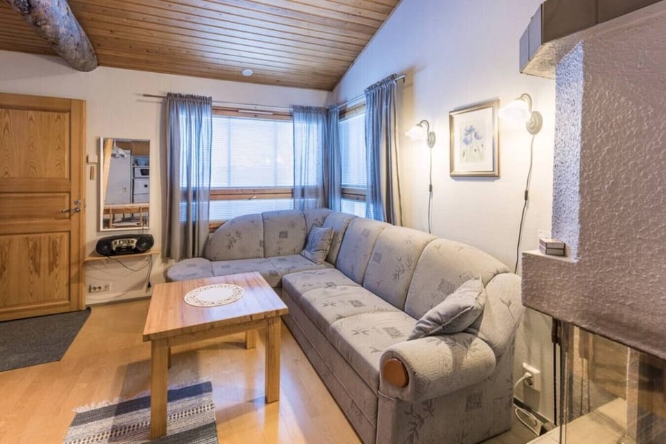 Bright living room with a comfortable corner sofa and large windows.