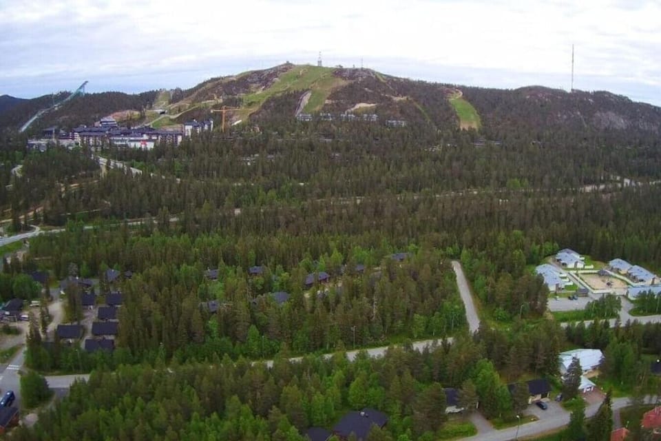 Aerial view of the Ruka fell and its slopes rising above the surrounding resort area.