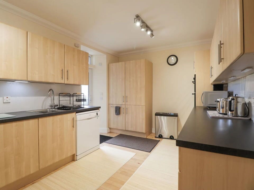 Furniture, Interior Design, Flooring, Kitchen, Floor, Wood, Cabinetry, Kitchen Appliance, Major Appliance, Countertop