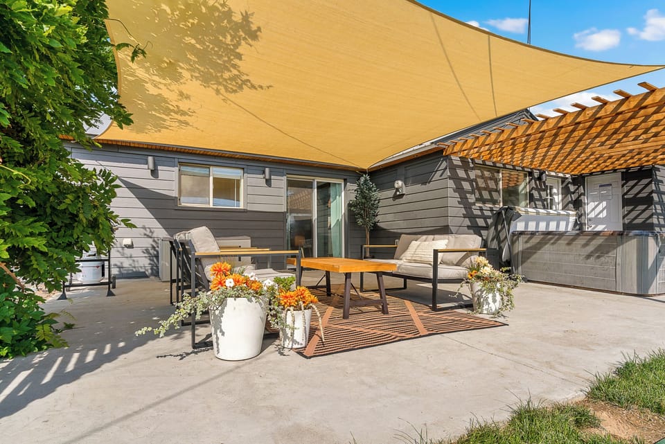 Private shaded patio with lounge seating and hot tub retreat