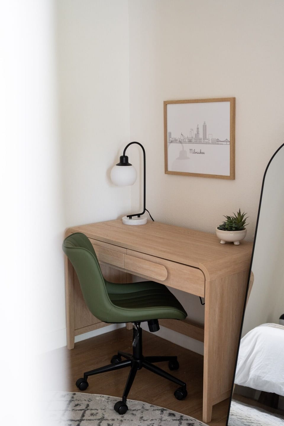Dedicated bedroom workspace with desk, comfortable office chair, and a touch of Milwaukee charm.