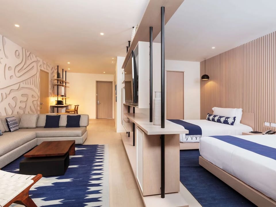 Unwind in a bright suite with lounge and cozy beds.