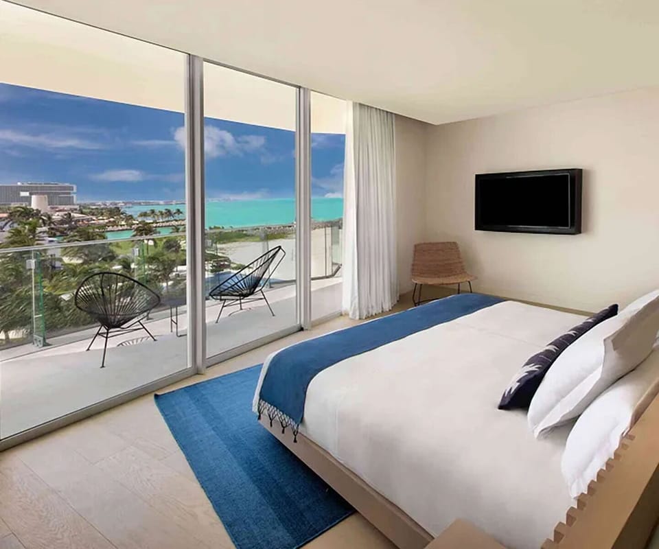 Wake up to turquoise ocean views from plush bed.