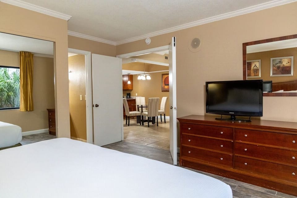 Recharge in a roomy bedroom with TV and easy storage.