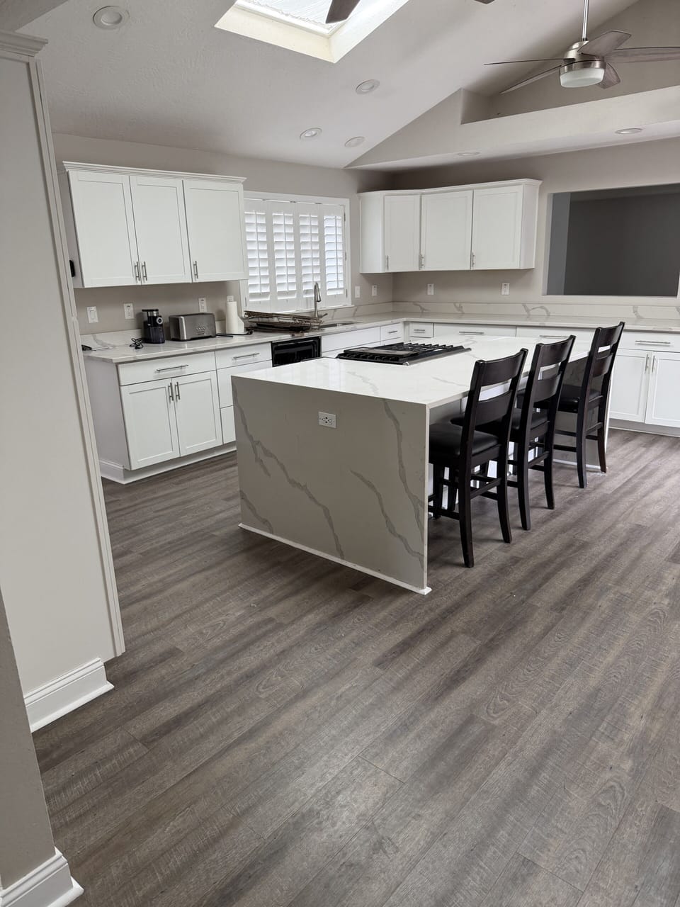 Bright modern kitchen with waterfall island and seating for four