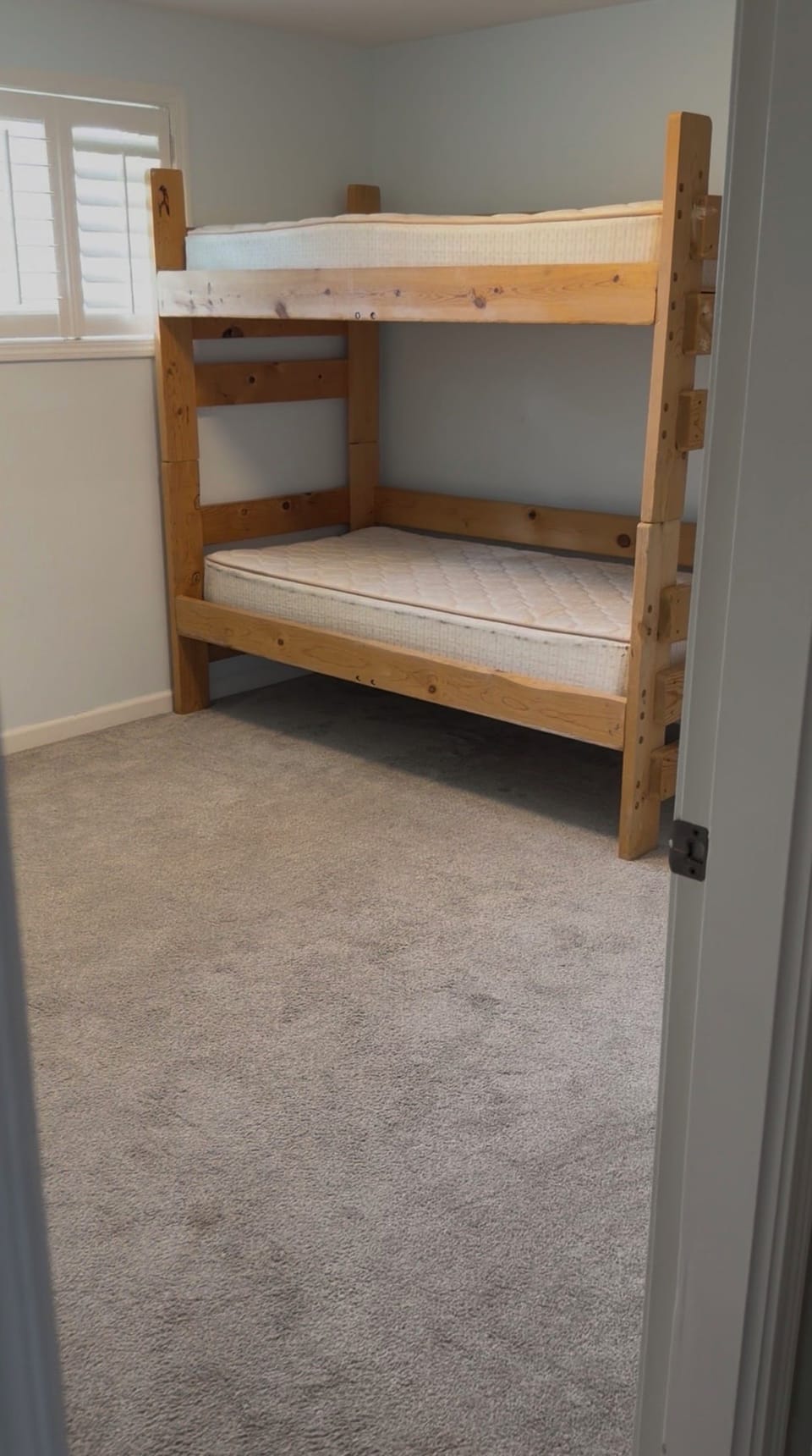 Cozy bunk room with rustic wood beds and bright, family-friendly style