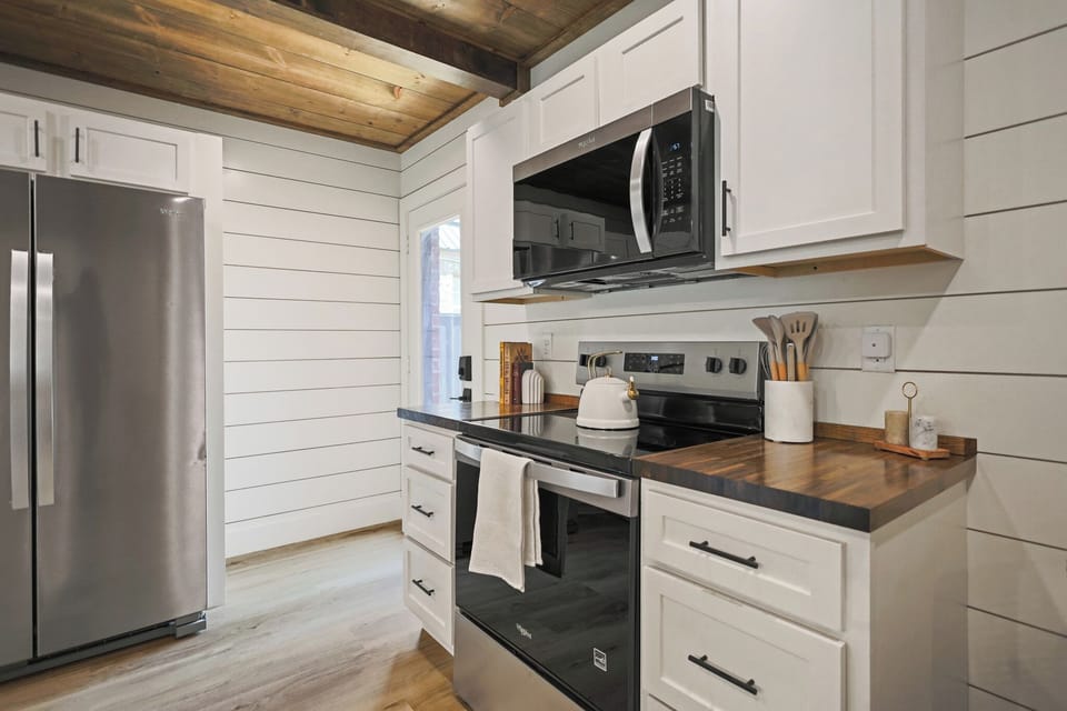 Modern farmhouse kitchen with butcher block counters and stainless appliances