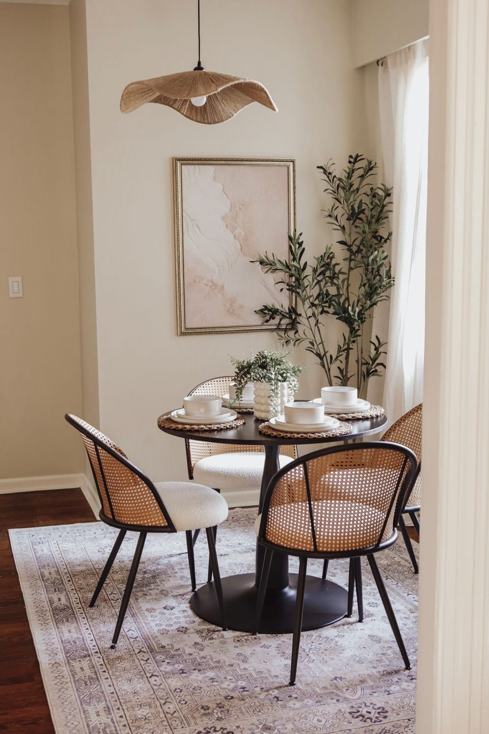 Sunny designer dining nook with woven chairs and elegant neutral styling