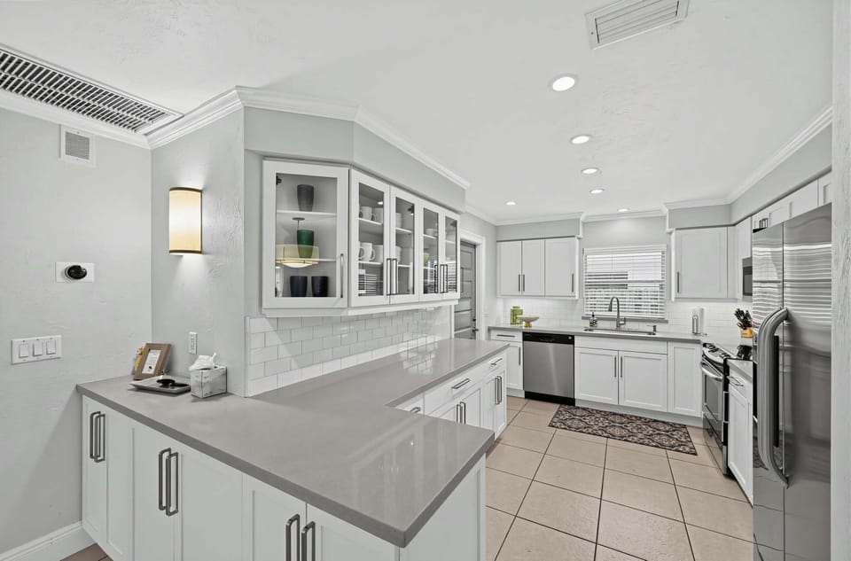 Bright, fully equipped kitchen with modern appliances and ample counter space.
