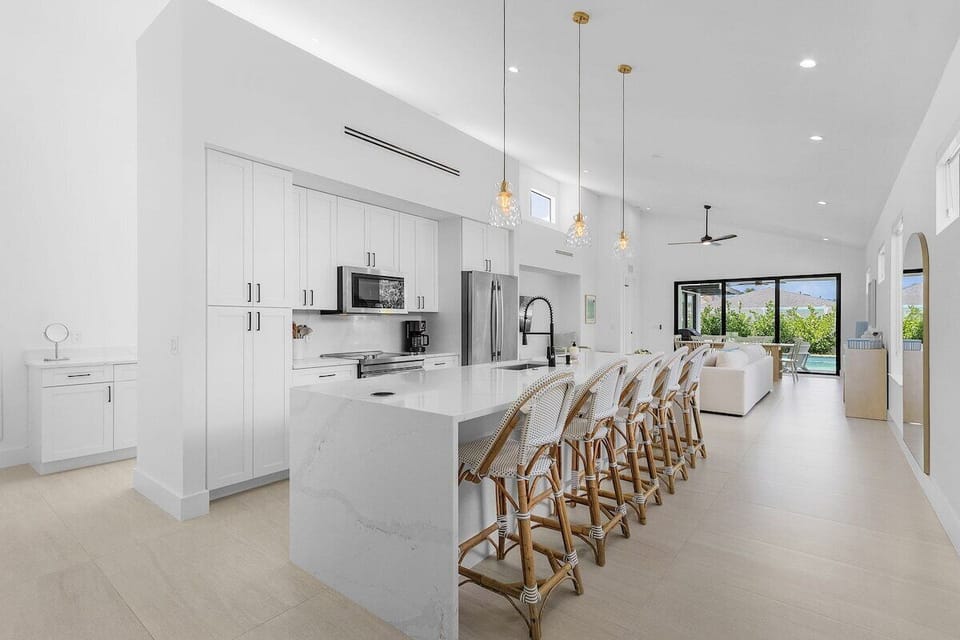 5 bar stools with a full kitchen.