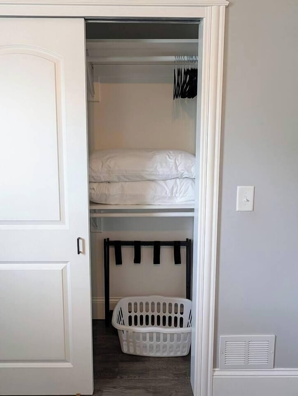 Extra pillows and blanket, luggage rack, laundry basket, hangers, and a portable humidifier are located in the closet.