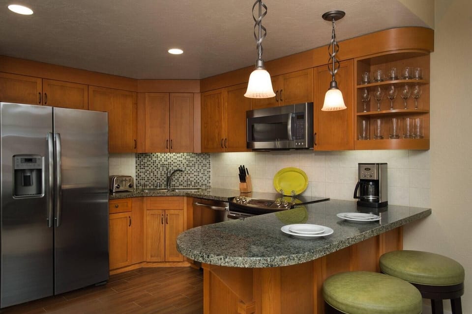 Modern kitchen with granite breakfast bar and stainless appliances