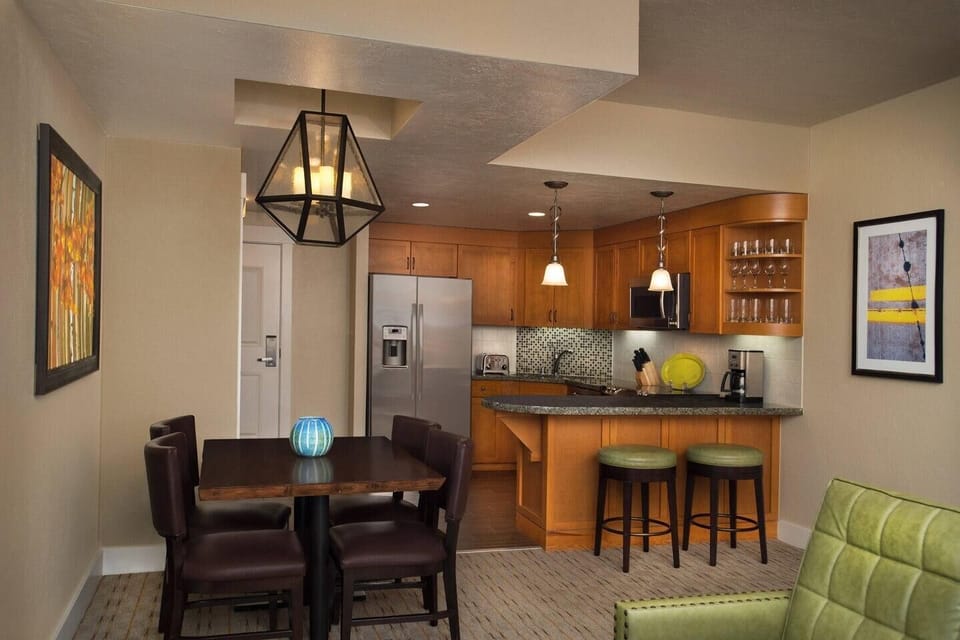 Open kitchen and dining area with breakfast bar and warm modern finishes