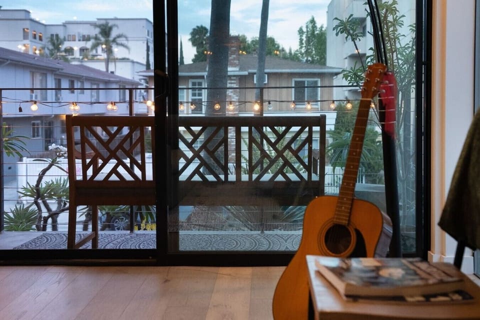 Private balcony · Outdoor seating · String lights · Floor-to-ceiling sliding doors · Neighborhood views · Garden
