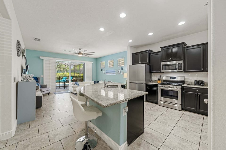 Kitchen Area w/ Large Island and Stainless-steel Appliances