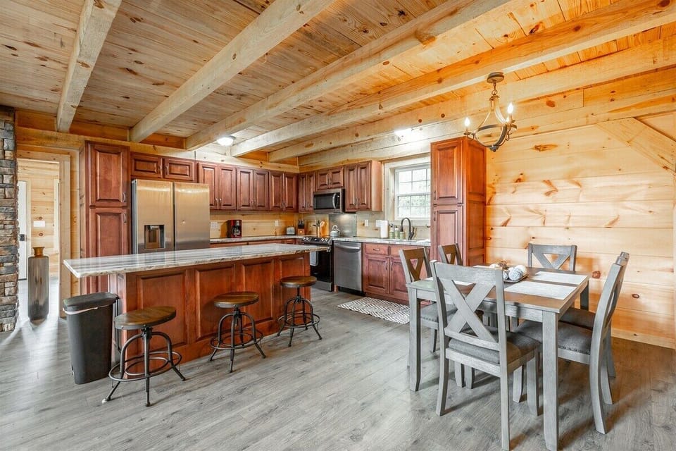 Kitchen area with Barstools and Dining table