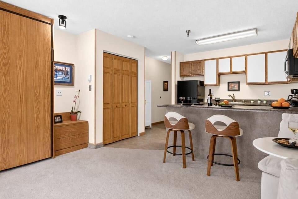 Welcoming kitchen and dining area with convenient breakfast bar seating for casual meals and morning coffee.