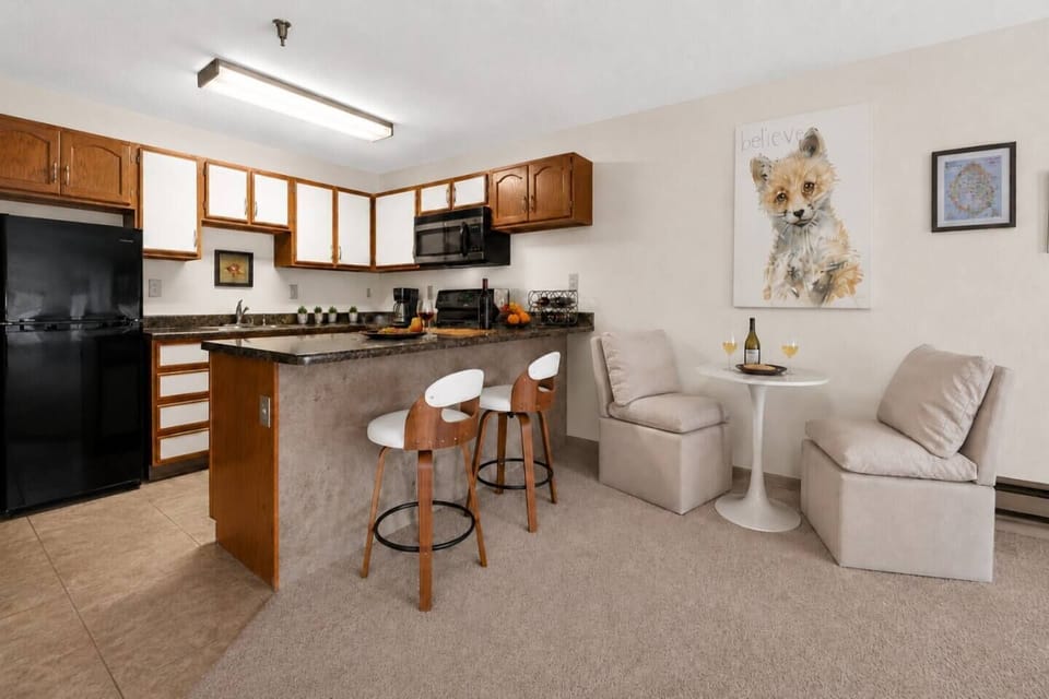 Open-concept kitchen and dining area with bar seating and a cozy spot to relax and enjoy a meal.