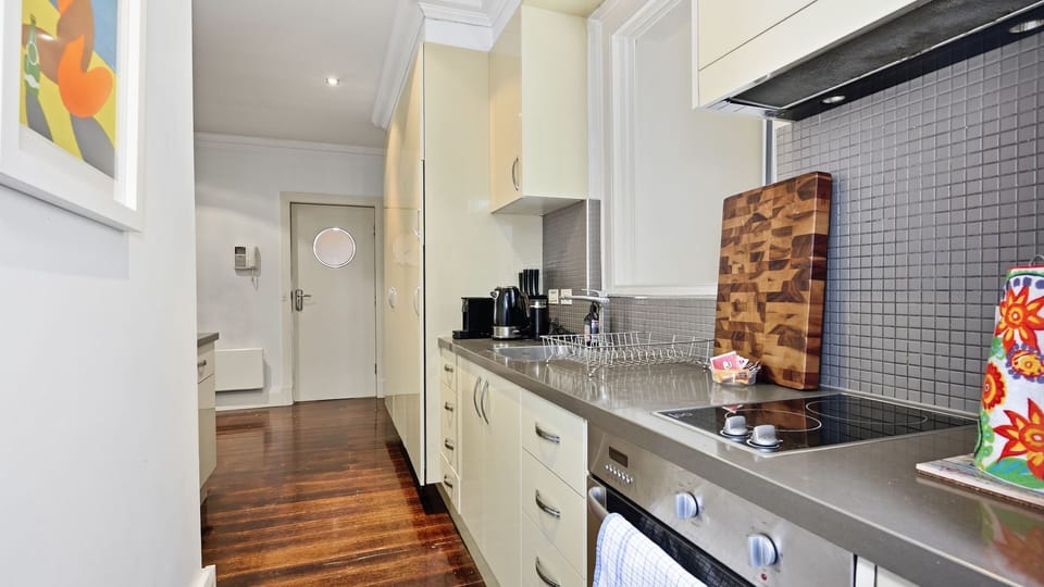 Compact and functional kitchen featuring a built-in cooktop.
