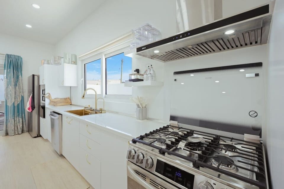 Spacious kitchen with a gas stove, oven, dishwasher, and plenty of counter space for preparing meals.