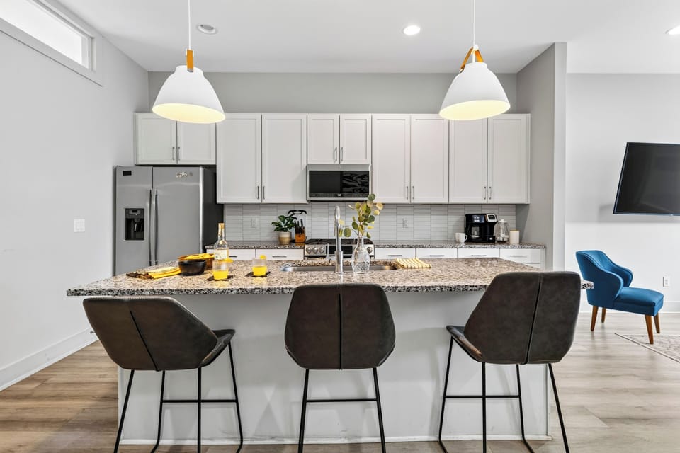Kitchen with stainless appliances and bar seating