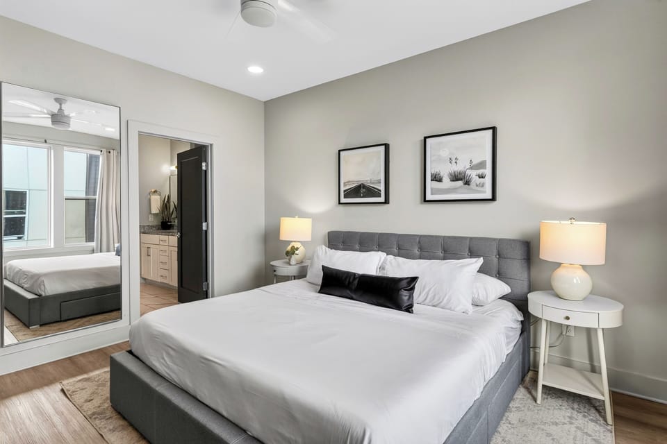 Bedroom with an upholstered bed and framed art