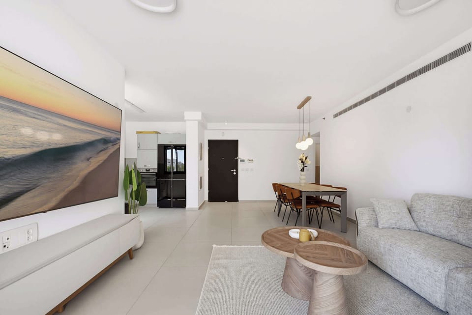 Gather friends around the stylish dining table in a grand open concept living space.