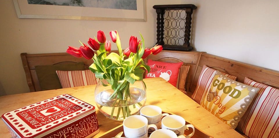 Cosy dining nook with bench seating and charming decorative touches.