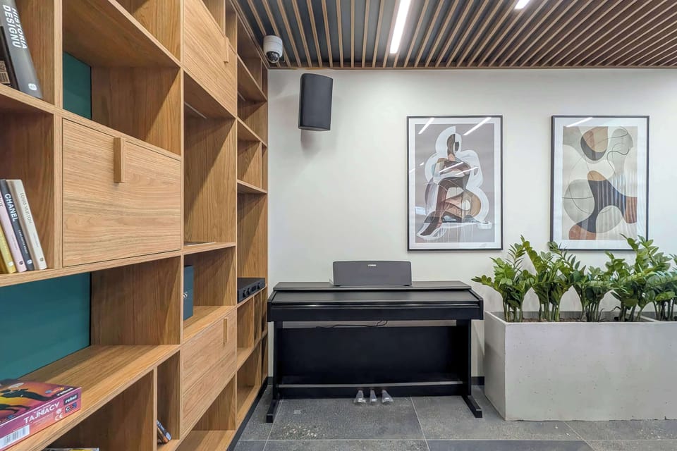 Comfortable seating area with wooden shelving and artwork.