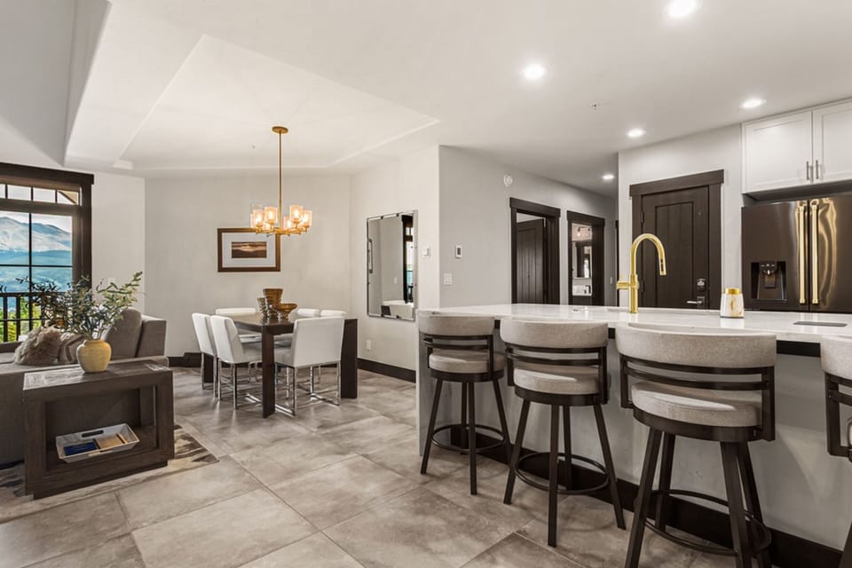 Your open-concept retreat seamlessly blends kitchen, dining, and living spaces with polished countertops, modern fixtures, and warm lighting—perfect for gathering or unwinding after a day of adventure.