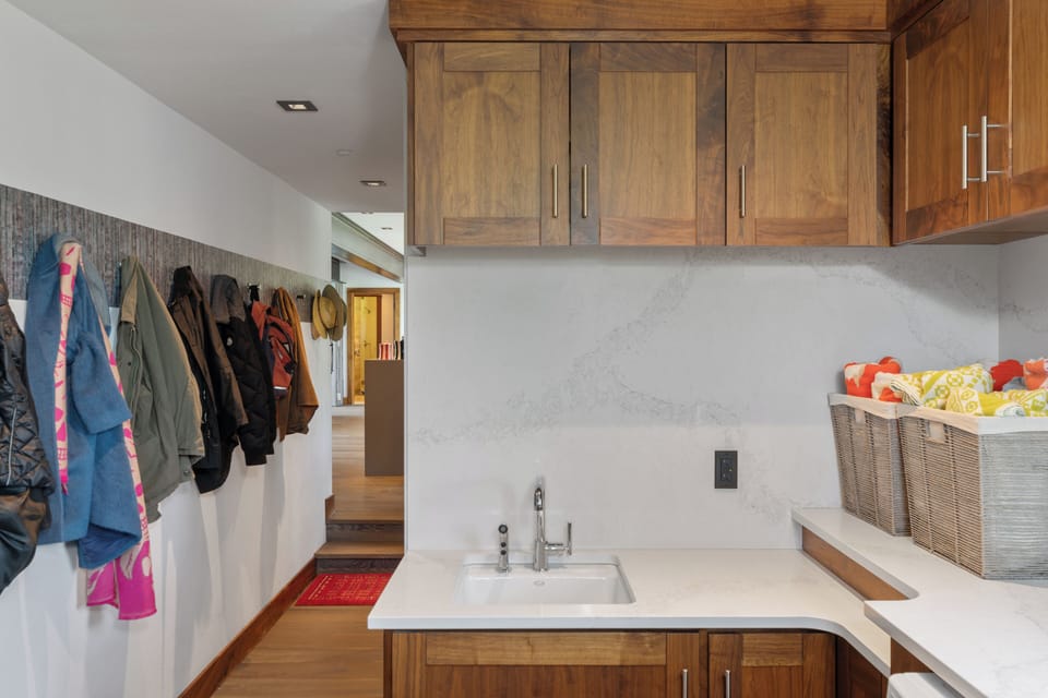 Practical mudroom area with coat hooks and cabinetry keeps your ski gear and outdoor essentials organized and within easy reach after a day on the slopes.