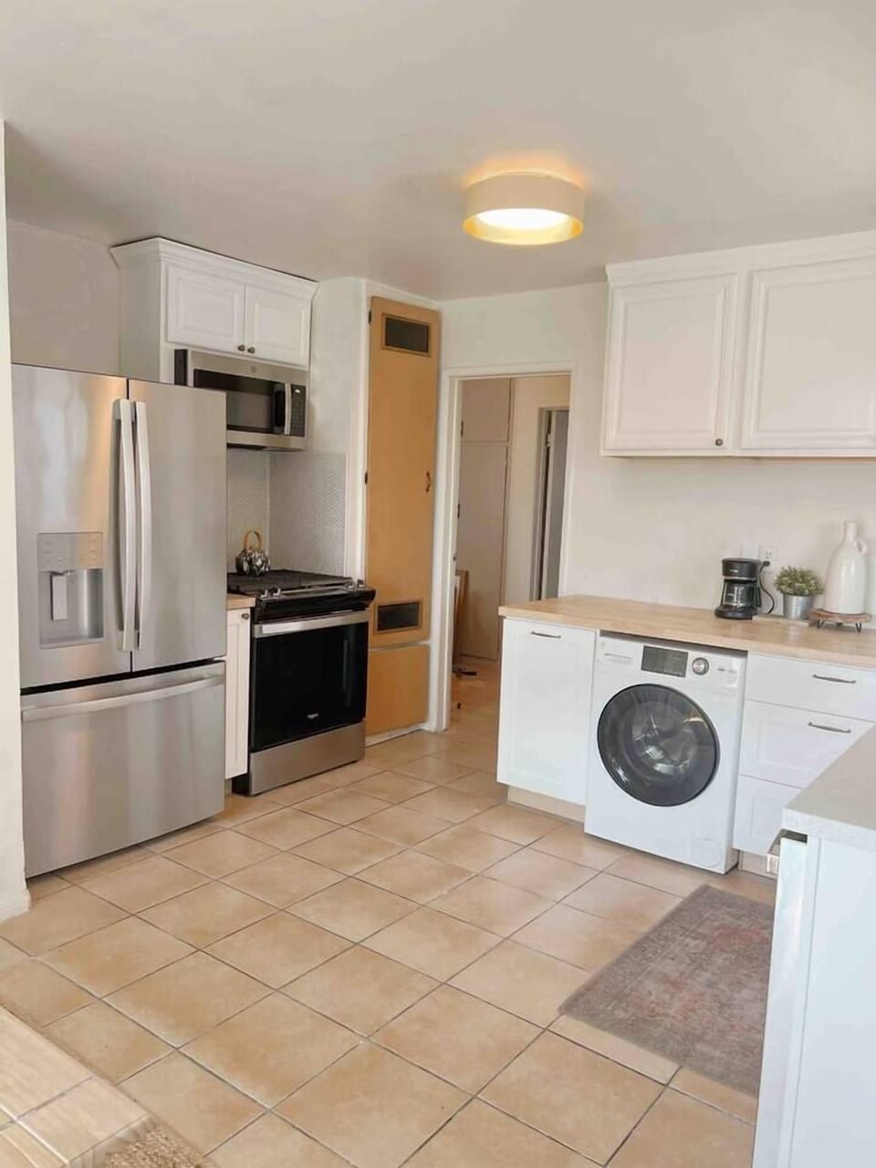 Kitchen with new appliances including gas range, dishwasher, fridge, microwave and combo washer/dryer
