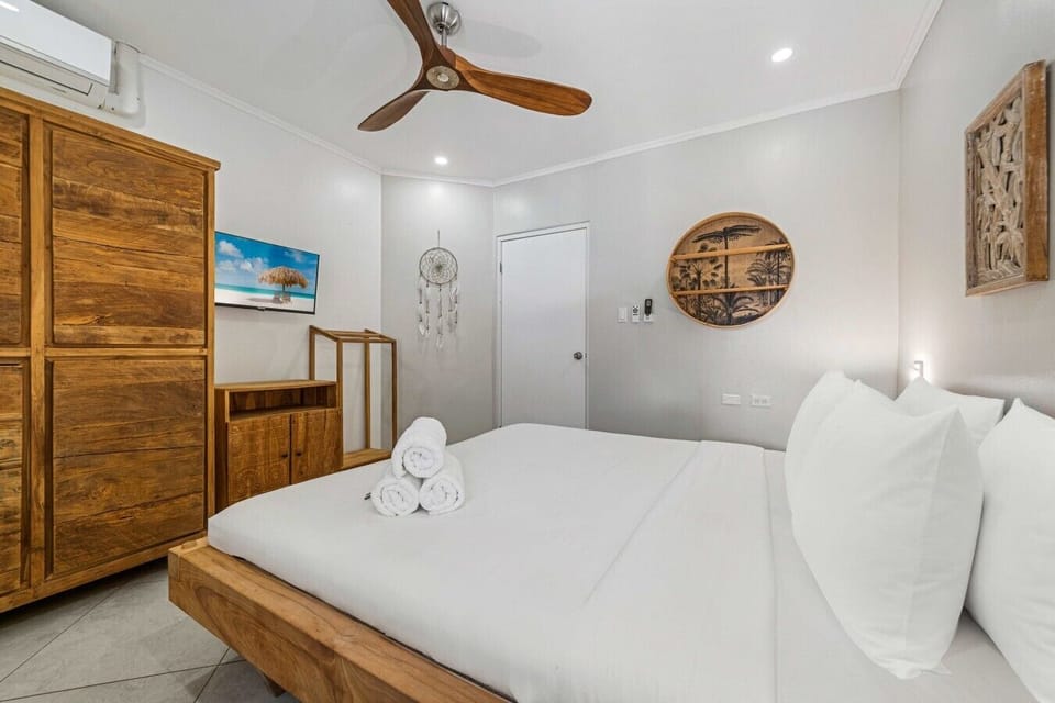 Rustic wood accents and serene décor bring warmth to this stylish bedroom, creating a relaxed, welcoming place to recharge and settle in after a full day of vacation fun