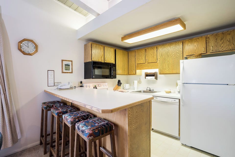 Your fully equipped kitchen features a spacious breakfast bar, modern appliances, and everything you need to prepare delicious meals during your mountain getaway.